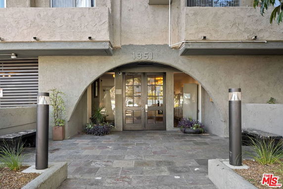 Front view of a building entrance with archway design.