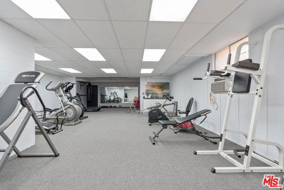 Indoor gym area with exercise equipment.