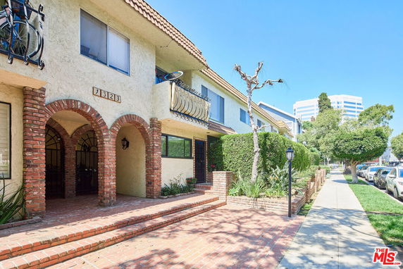 Front view of a two-story building with arches and balconies.
