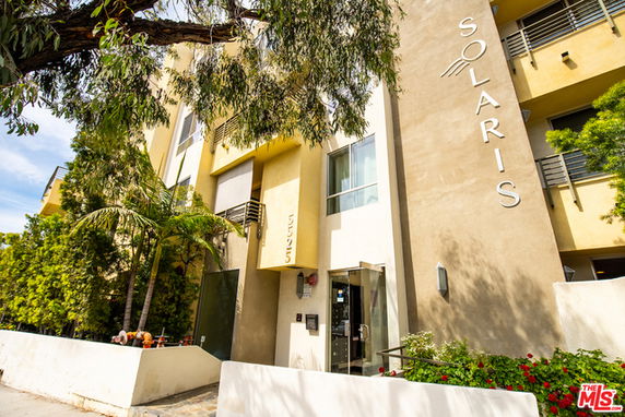 Front view of a multi-story building with large windows and a sign reading 'Solaris'.