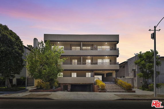 Front view of a three-story building with balconies.