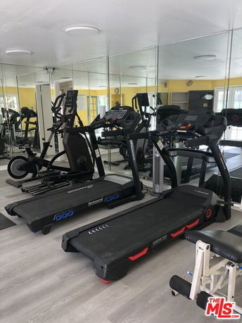 Indoor gym area with treadmills and fitness equipment.