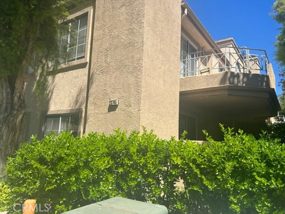 Front view of a two-story house with a balcony.