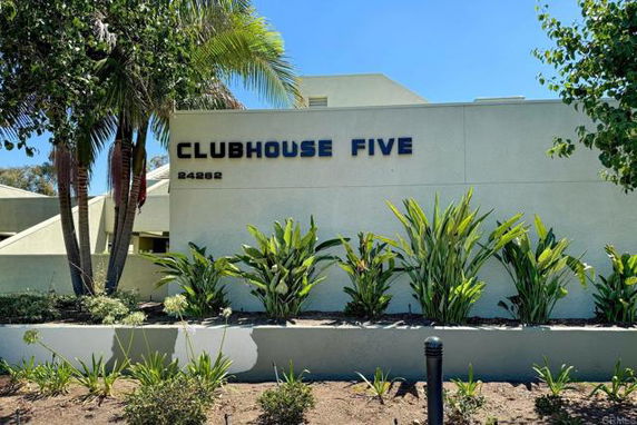Front view of a building with the name 'Clubhouse Five' displayed on the wall.