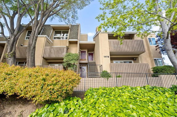 Front view of a multi-story residential building with balconies.