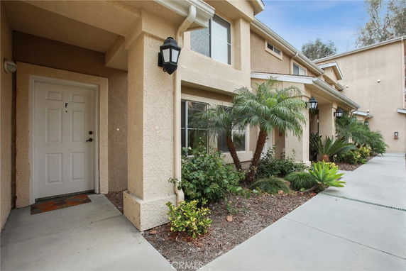 Front view of a two-story residential building with a door labeled F.