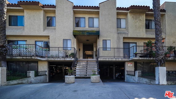 Front view of a multi-story building with an elevated entrance.
