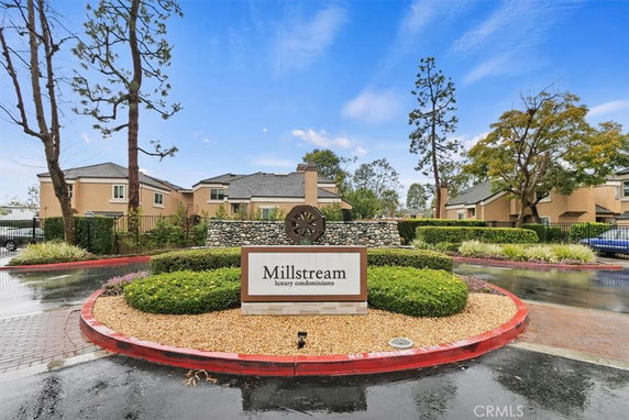 Front view of luxury condominiums with a prominent Millstream sign.