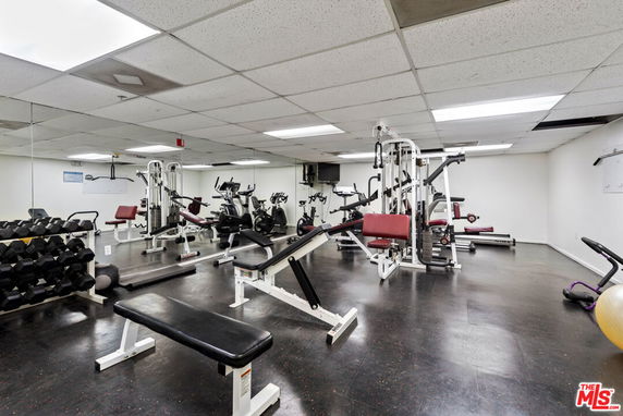 Indoor gym area with various fitness equipment.
