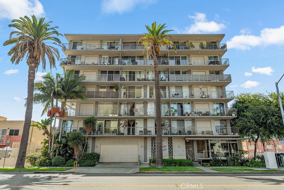 Front view of a multi-story residential building with balconies.