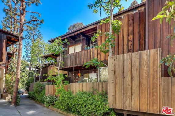 Front view of a multi-story wooden house with balconies.