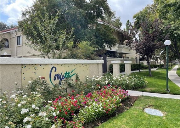 Entrance view of a residential building named Confetti with landscaping and pathway.