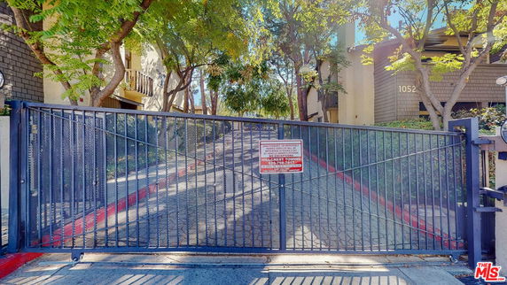 Front view of a gated entrance to a residential building complex.