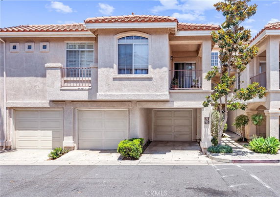 Front view of a two-story townhouse with garages.