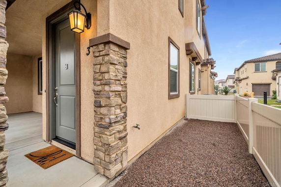 Front view of a house with stone pillars and a welcoming entrance.