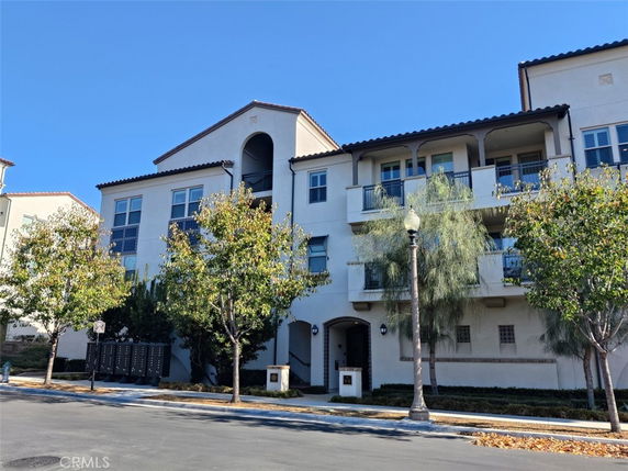 Front view of a multi-story residential building with balconies.