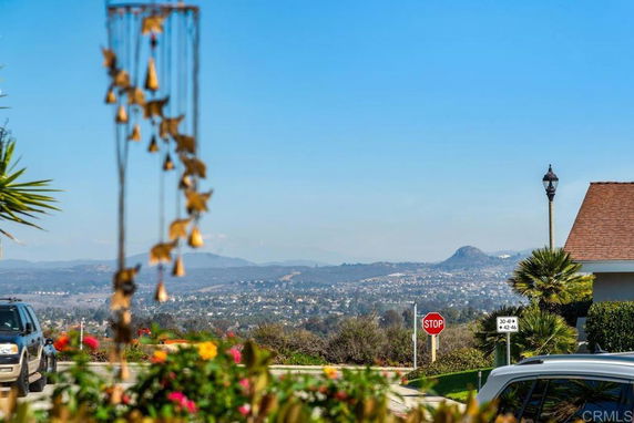 View of surrounding areas with hills and residential homes in the background.