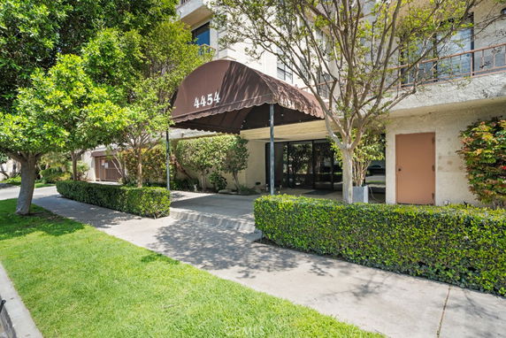 Front view of a multi-story building with entrance canopy.