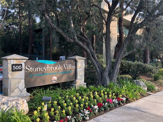 Front view of a building behind a sign reading 'Stoneybrook Villas: A Condominium Community.'