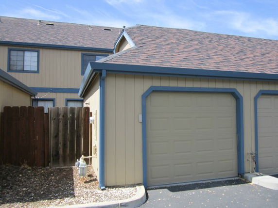 Front view of a two-story house with an attached garage.