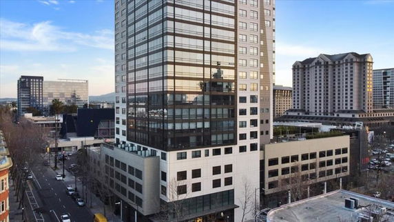 Front view of a multi-story office building in a city setting.