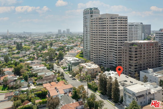 Panoramic view of a cityscape with tall buildings and residential areas.