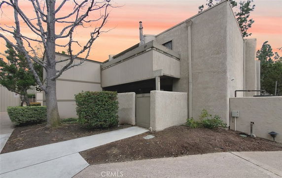 Front view of a modern multi-level building with a minimalistic design.