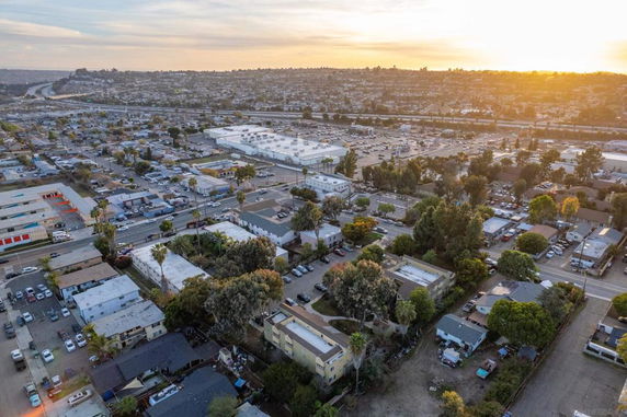 Panoramic view of a suburban area with various residential and commercial buildings visible from above.