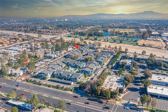 Aerial view of a residential area with multiple houses and surrounding landscape.