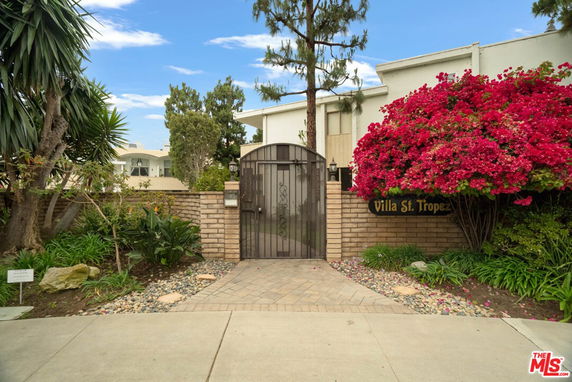 Front view of a building with a gated entrance named Villa St. Tropez.