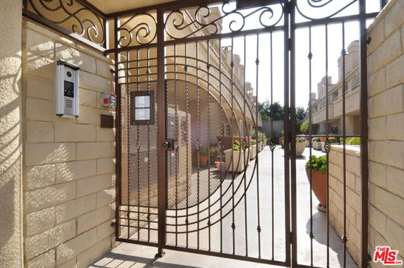 Gated entrance to a residential building with a modern design.