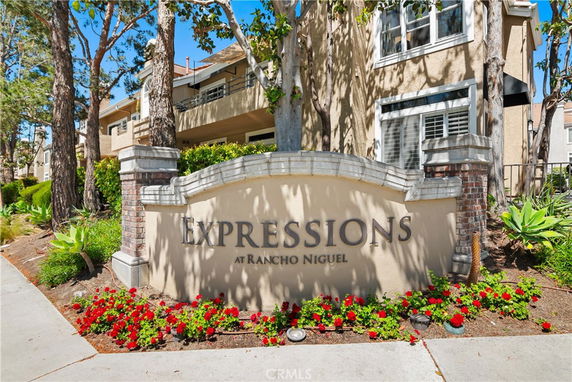 Front view of a residential building with a sign reading 'Expressions at Rancho Niguel'.