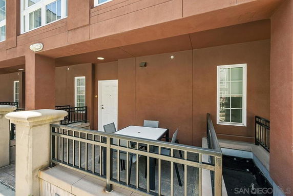 Front view of a building with a small outdoor sitting area.