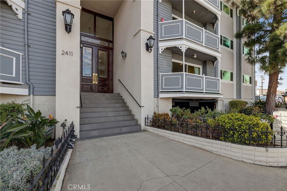 Front view of a multi-story residential building with balconies.