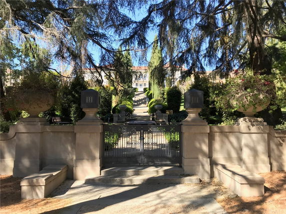 Front view of an elevated structure with decorative entrance and gate.