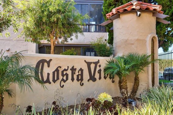 Front view of a building with a wall sign saying 'Costa Vida' and a tower-like architectural feature.