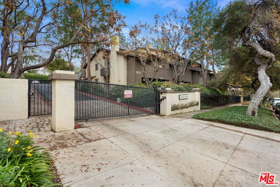 Front view of a residential building with a gated entrance.