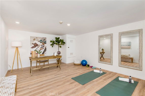 Indoor room with exercise mats, mirrors, and a desk for recreational activities.
