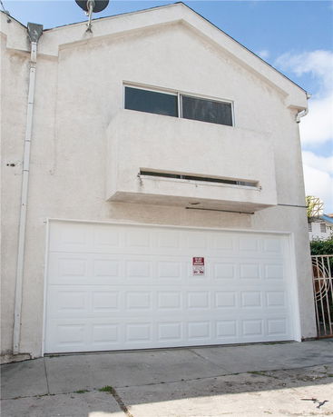 Front view of a two-story house with a garage.