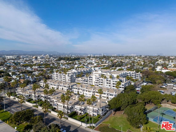 Panoramic view of a residential area with multi-story buildings and surrounding cityscape.