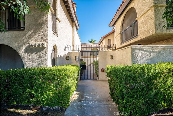 Front view of a two-story building with archways and a gated entrance.