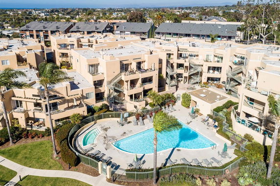 Aerial view of a residential complex with a central swimming pool.