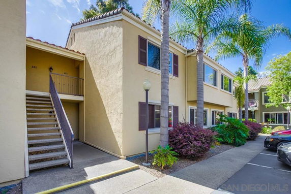 Front view of a two-story apartment building with an exterior staircase.
