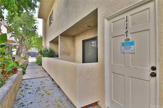 Front view of a building with a walkway and door entrance.