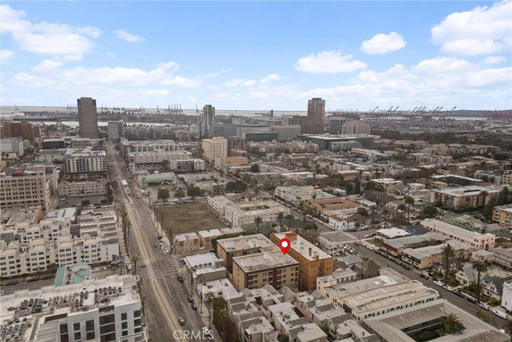 Panoramic view of an urban area with buildings and a port in the distance.