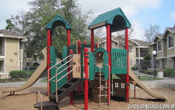 Playground with slides in an outdoor residential area.