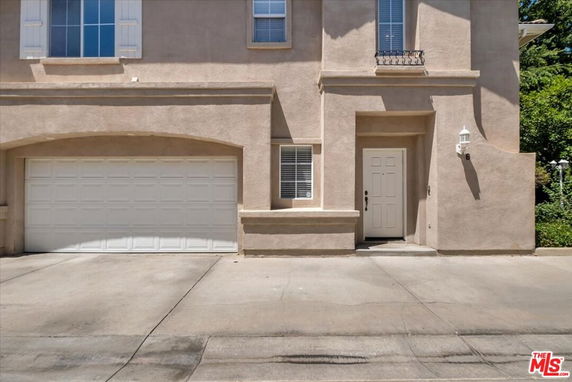 Front view of a house with a garage and a main entrance door.