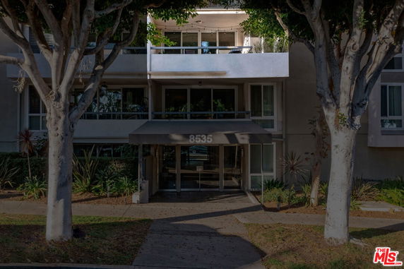 Front view of a multi-story building entrance with a canopy.