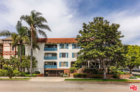 Front view of a multi-story residential building with balconies.
