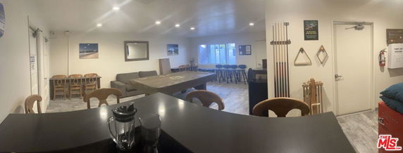 Indoor recreation area with a billiards table and seating.